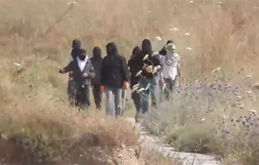 Thumbnail preview image for the video titled: Masked settlers from the Yitzhar settlement invaded the village of Asira al-Qibliyah