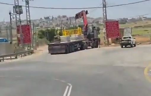 Thumbnail preview image for the video titled: Israeli forces set up a metal gate to restrict the movement of Palestinians into and out of the village of Deir Ballout