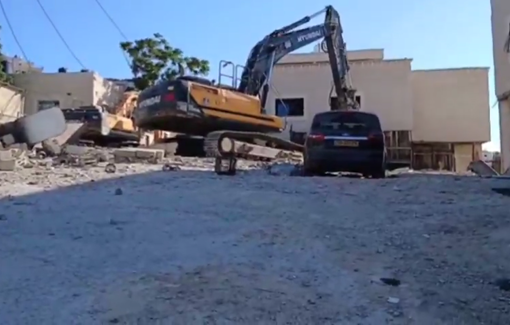 Thumbnail preview image for the video titled: Israeli Hyundai bulldozers demolishing a two-story house in the town of Hizma, northeast of occupied Jerusalem