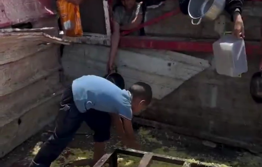 Thumbnail preview image for the video titled: A child gathers scattered grains of rice from the ground, in an attempt to satisfy his hunge