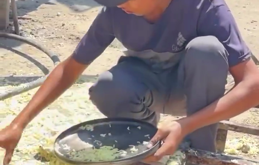 Thumbnail preview image for the video titled: Child picks up spilled rice from the ground at a charity kitchen