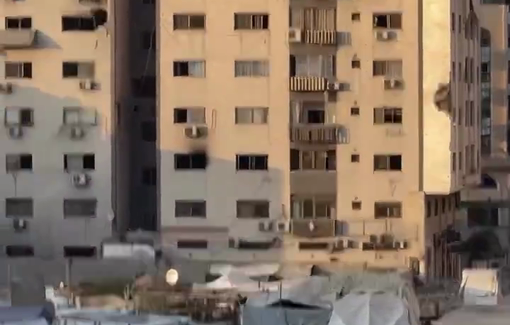 Thumbnail preview image for the video titled: Photojournalist Mahmoud Abu Hamda injured while documenting Israel's bombing of Al-Roya Tower