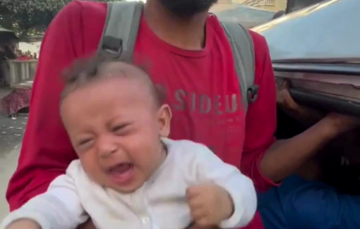 Thumbnail preview image for the video titled: Father soothes baby during displacement