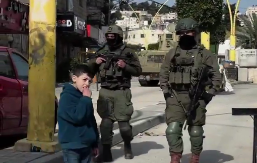 Thumbnail preview image for the video titled: Palestinian children playing face-to-face with heavily armed soldiers in the southern area of Hebron