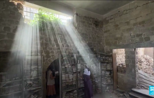 Thumbnail preview image for the video titled: Volunteers are working carefully to salvage what remains of the 20,000 precious books in the rubble of historic library