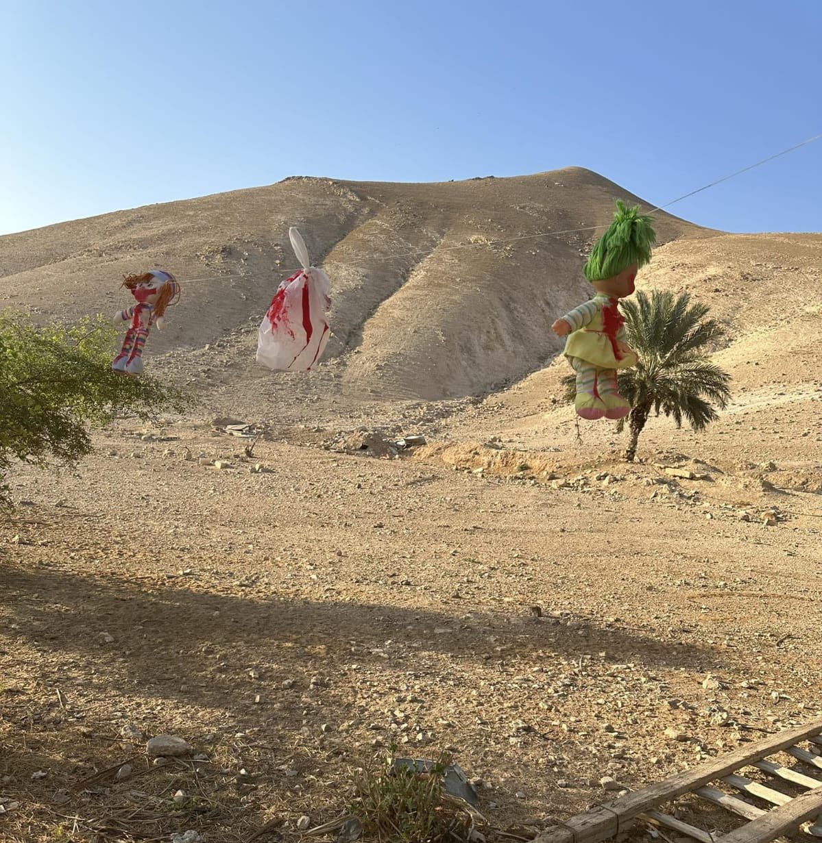 Thumbnail preview image for the video titled: Dolls covered with 'blood' placed reportedly by settlers next to the Bedouin Khabna Elementary School in Al-Marjat