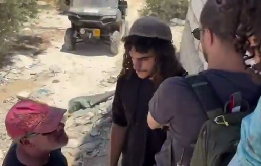 Thumbnail preview image for the video titled: Settler gangs, backed by soldiers, violently prevent an activist from fixing a Palestinian home’s door in Jurish