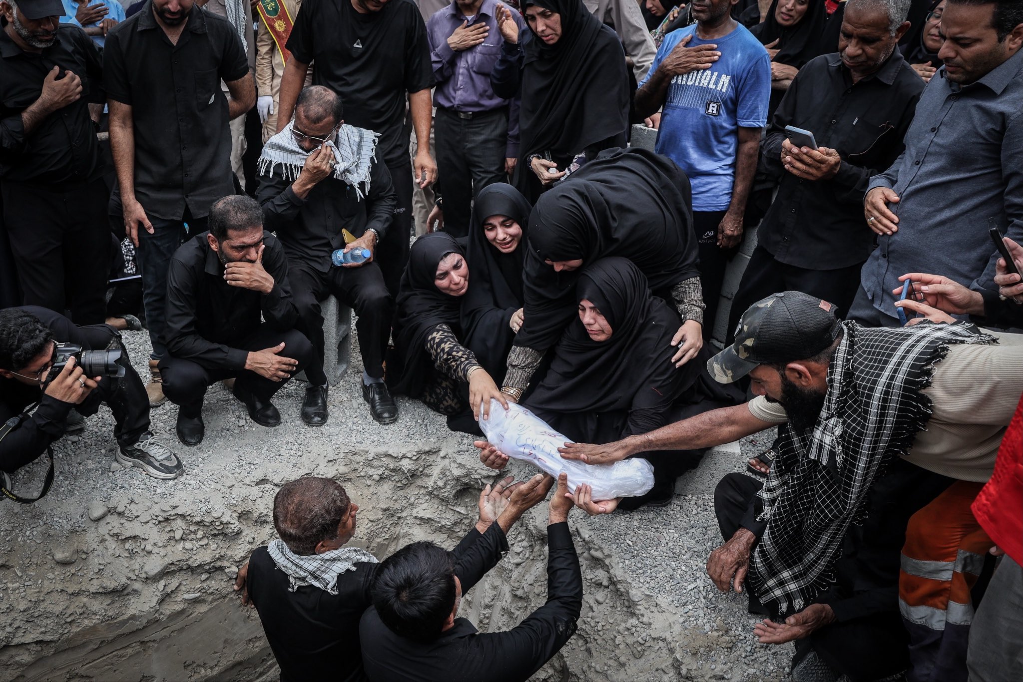 Thumbnail preview image for the video titled: A funeral ceremony held for 62 recovered body parts and remains belonging to the student martyrs of Minab School