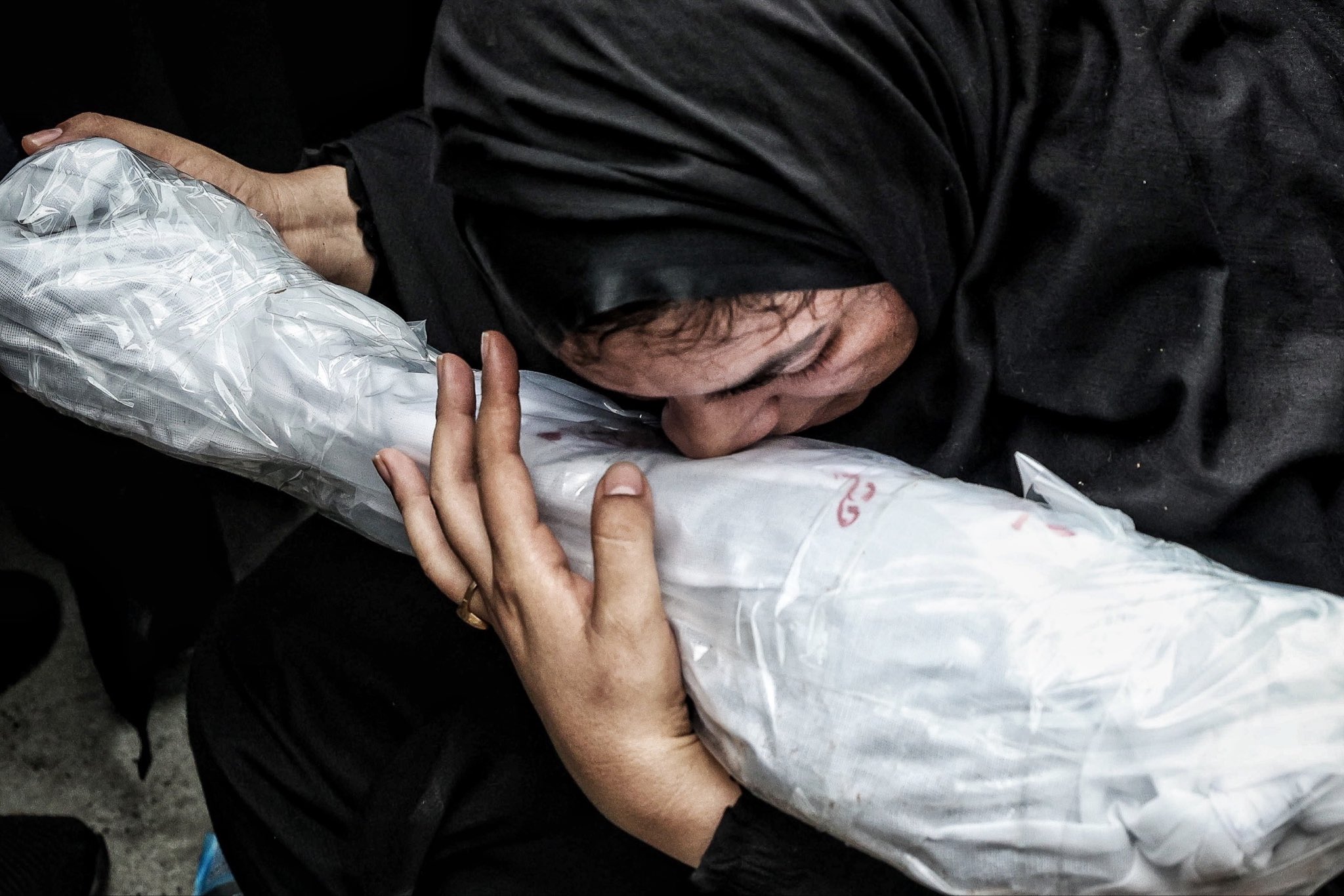 Thumbnail preview image for the video titled: A funeral ceremony held for 62 recovered body parts and remains belonging to the student martyrs of Minab School