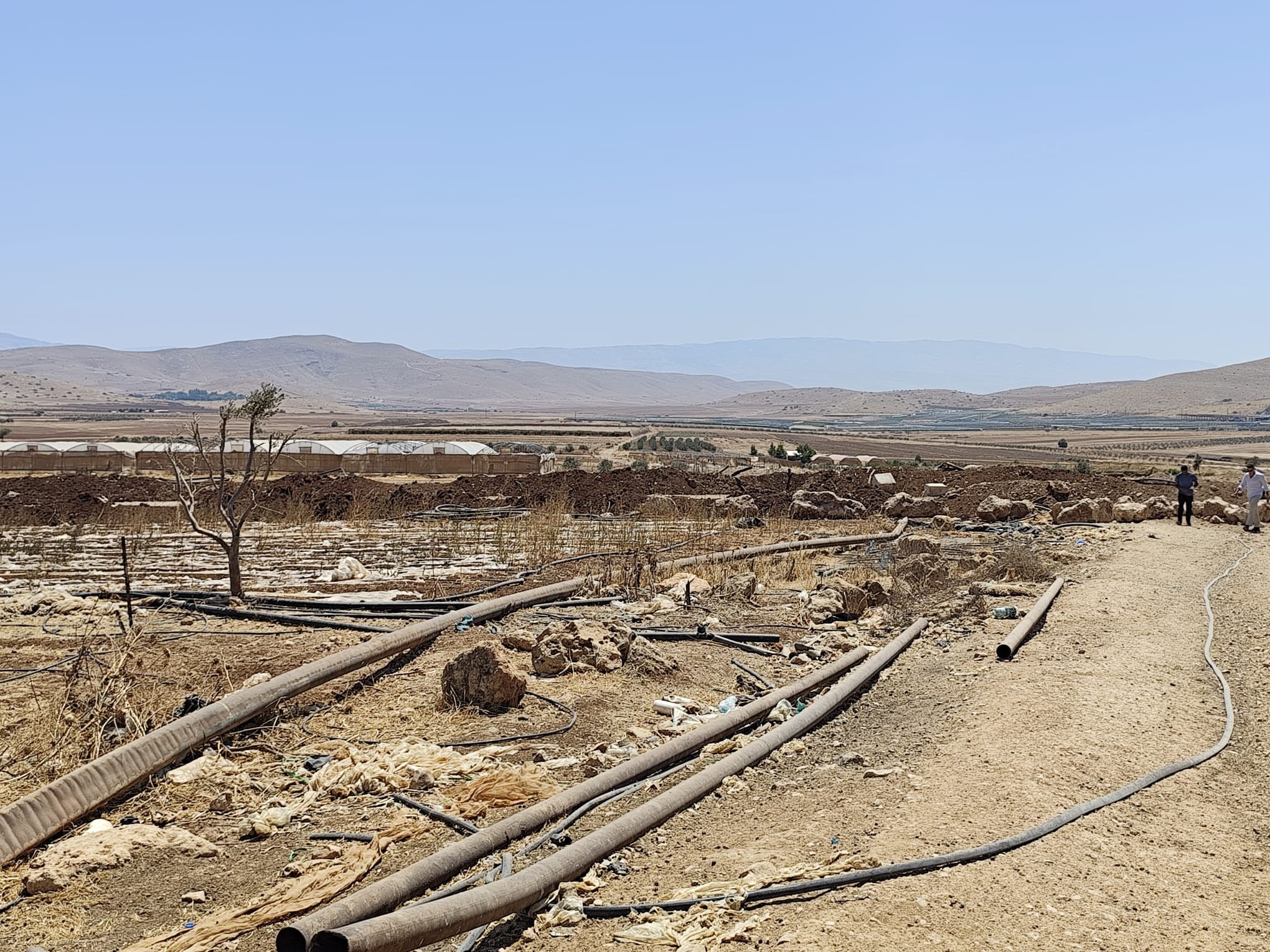 Thumbnail preview image for the video titled: The "Crimson Thread" barrier is built over Palestinian agricultural lands and greenhouses in the Jordan Valley