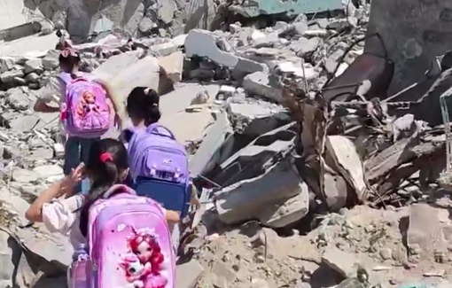 Thumbnail preview image for the video titled: Children climb the rubble of homes to reach their school in Gaza