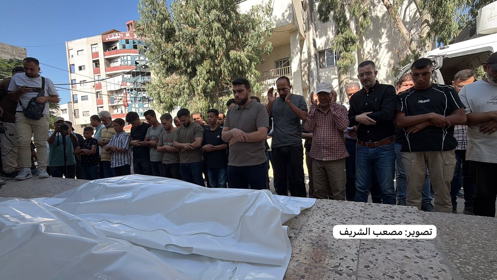 Thumbnail preview image for the video titled: Funeral prayer for Palestinians killed in their sleep by Israeli bombing of their residence